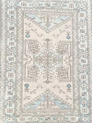 A white rug with a blue and white pattern on it.