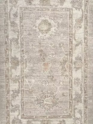 A close up of a rug with a floral pattern on it.