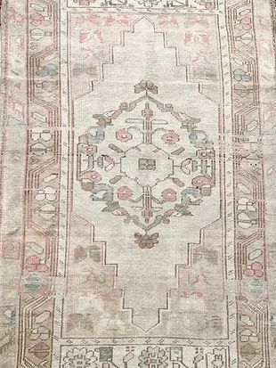 A close up of a rug with a floral pattern on it.