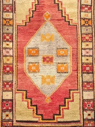 A close up of a rug with a geometric pattern on it.