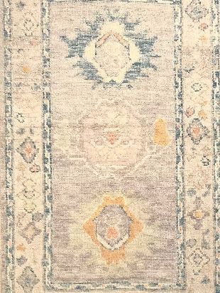 A close up of a rug with a pattern on it.