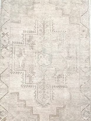 A close up of a rug with a pattern on it.