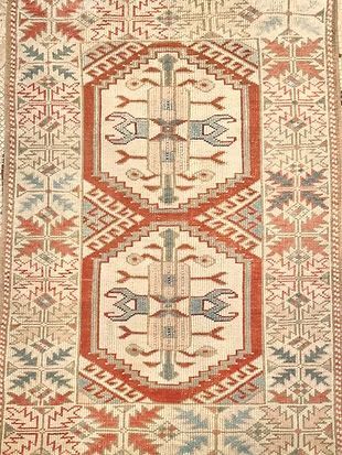 A close up of a rug with a geometric pattern on it