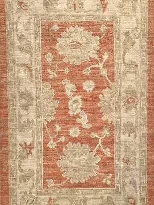 A close up of a rug with a floral pattern on it.