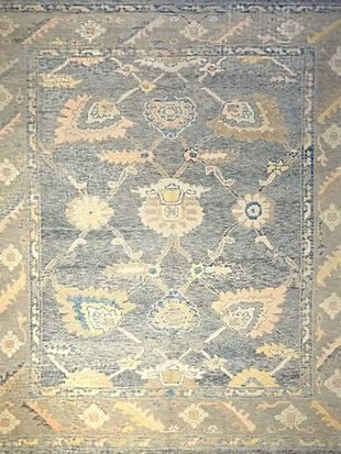 A close up of a rug with a floral pattern on it.