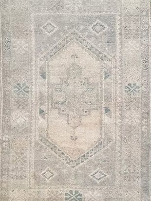 A close up of a rug with a pattern on it.