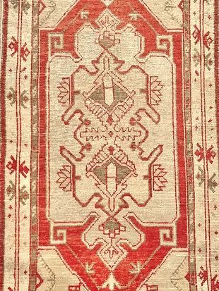 A close up of a red and white rug with a pattern on it.