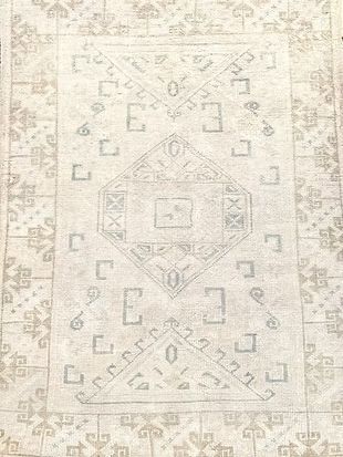 A close up of a rug with a geometric pattern on it.