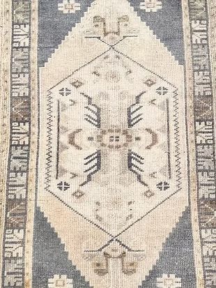 A close up of a rug with a geometric pattern on it.