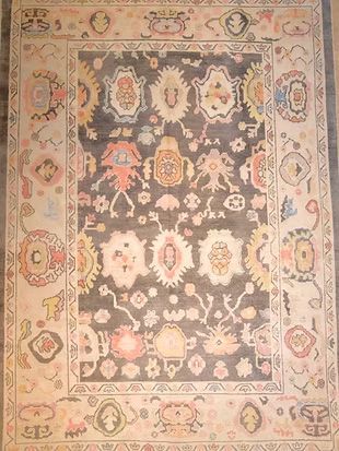 A rug with a floral pattern on it is sitting on a table.