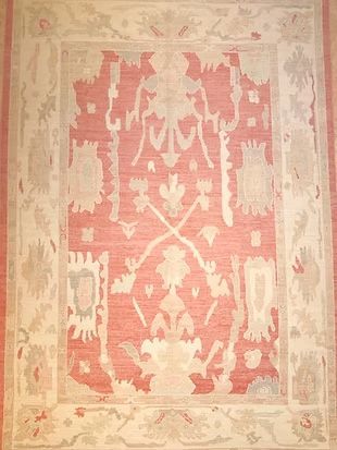 A red and white rug with a floral design on it