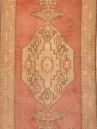 A close up of a rug with a pattern on it.