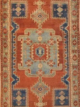 A red and blue rug with a geometric pattern on it