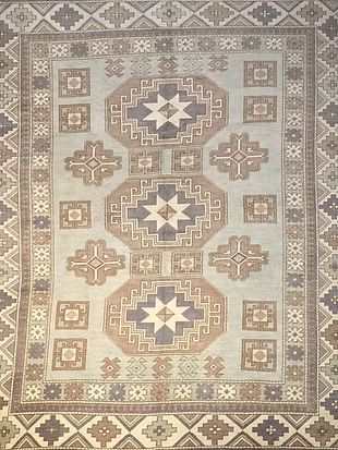 A rug with a pattern on it is sitting on a table.