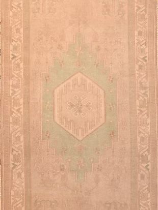 A close up of a rug with a geometric pattern on it.