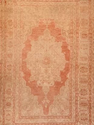 A close up of a rug with a floral pattern on it.