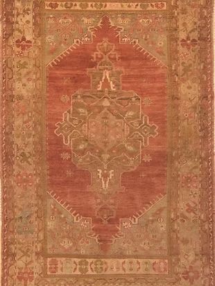 A close up of a red rug with a pattern on it.