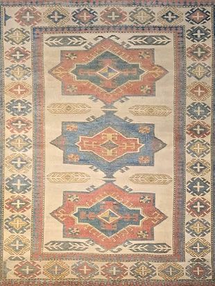 A rug with a geometric pattern on it is sitting on a table.