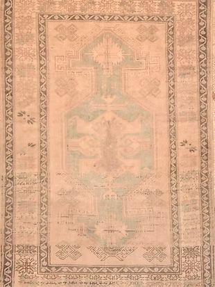 A rug with a cross on it is sitting on a table.