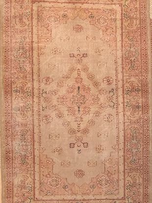 A close up of a rug with a floral pattern on it.