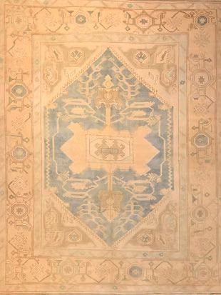 A rug with a geometric pattern on it is sitting on a table.