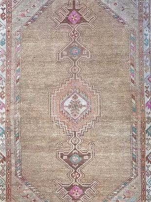 A close up of a rug with a geometric pattern on it.