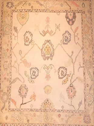 A square rug with flowers and leaves on it