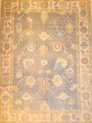 A rug with a floral pattern on it is sitting on a table.