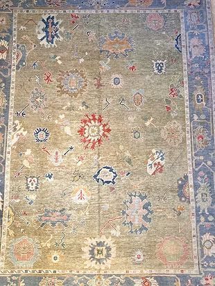 A rug with a floral pattern on it is sitting on a table.