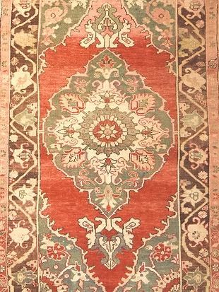 A close up of a rug with a floral pattern on it.
