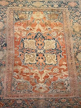 A close up of a rug with a floral pattern on it.