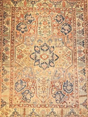 A close up of a rug with a floral pattern on it.