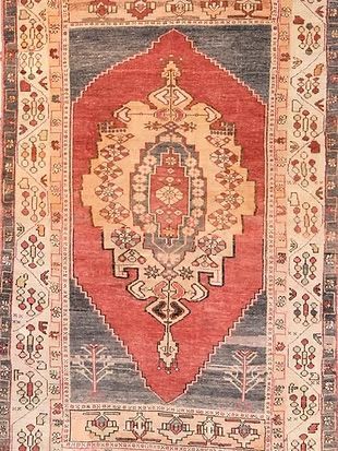 A close up of a rug with a floral pattern on it.