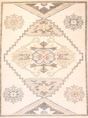 A white rug with a geometric pattern on it.