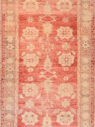 A red and white rug with a floral pattern on it.