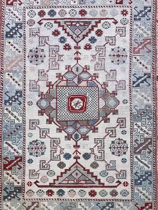 A close up of a rug with a geometric pattern on it.