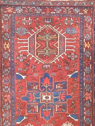 A red rug with a blue and white pattern on it