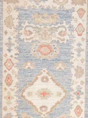 A blue and white rug with a floral pattern on it.