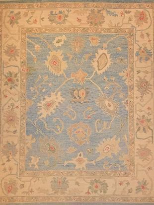 A blue and white rug with a floral pattern on it.