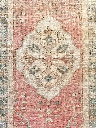 A close up of a rug with a floral pattern on it.