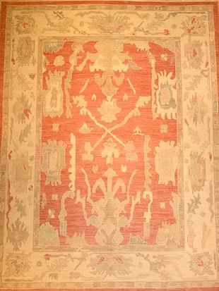 A red and white rug with a floral pattern on it.