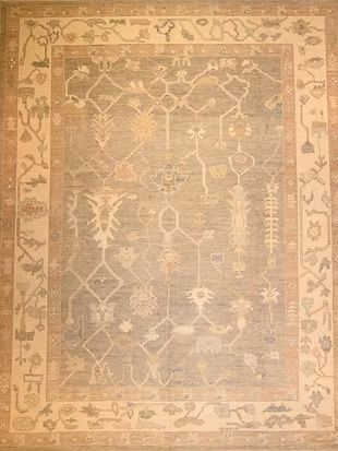 A rug with a floral pattern on it is on a wall.