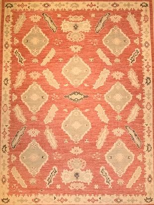 A red and white rug with a geometric pattern on it.