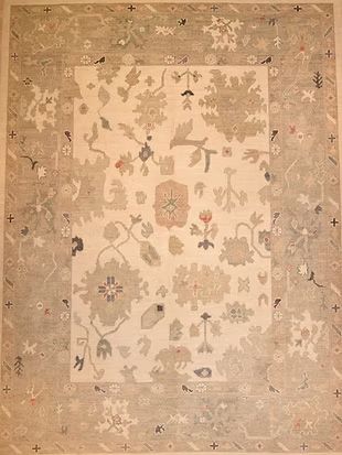 A rug with a floral pattern on it is sitting on a table.