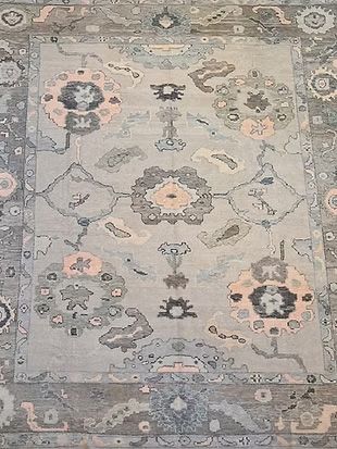 A close up of a rug with a floral pattern on it.