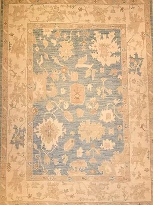 A blue and white rug with a floral pattern on it
