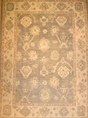 A rug with a floral pattern on it is sitting on a table.