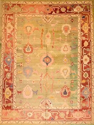 A colorful rug with a red border is sitting on a table.