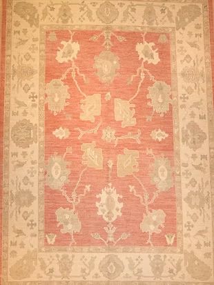 A red and white rug with a floral pattern on it.