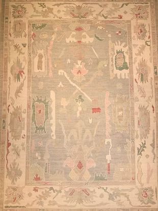 A rug with a lot of patterns on it is sitting on a table.